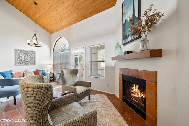 living room featuring dark tile patterned flooring, wood ceiling, a tile fireplace, and high vaulted ceiling