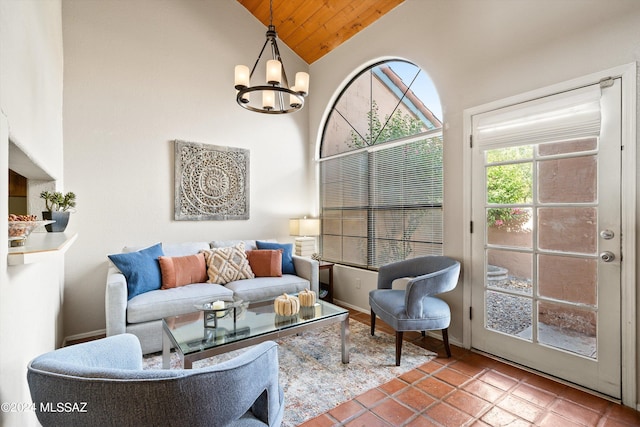 living room featuring high vaulted ceiling, tile patterned floors, and a chandelier