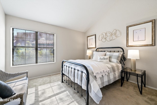 bedroom with vaulted ceiling and light carpet