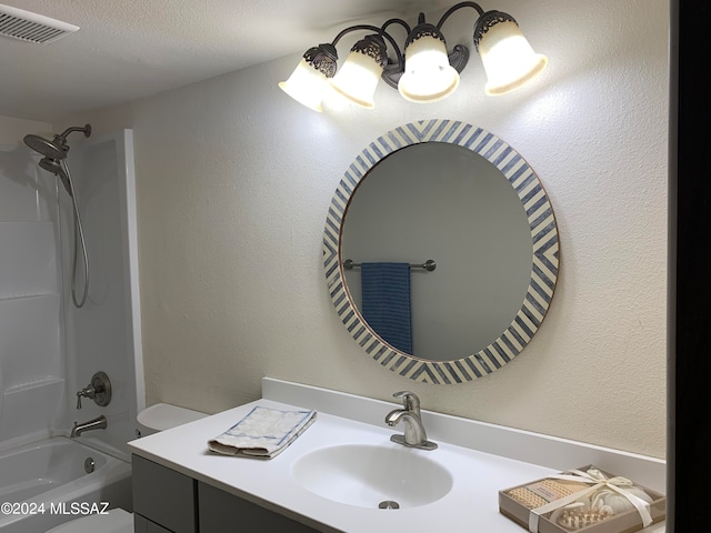 full bathroom featuring vanity, a textured ceiling, bathtub / shower combination, and toilet