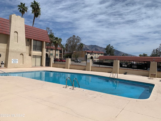 view of pool featuring a patio and a mountain view