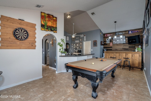 rec room featuring indoor wet bar, a textured ceiling, ceiling fan, vaulted ceiling, and billiards