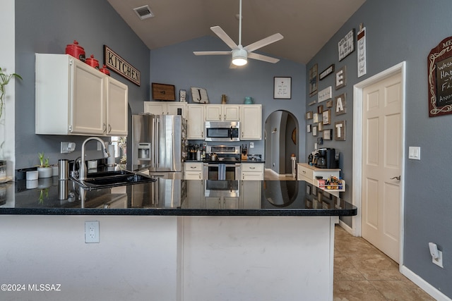 kitchen featuring appliances with stainless steel finishes, sink, kitchen peninsula, white cabinetry, and light tile patterned floors