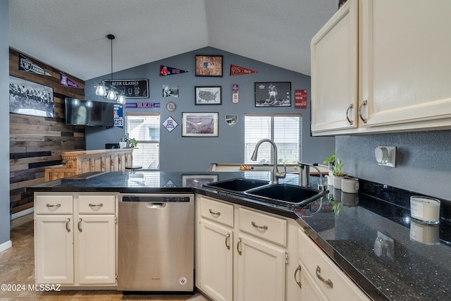 kitchen featuring sink, dishwasher, vaulted ceiling, wooden walls, and decorative light fixtures