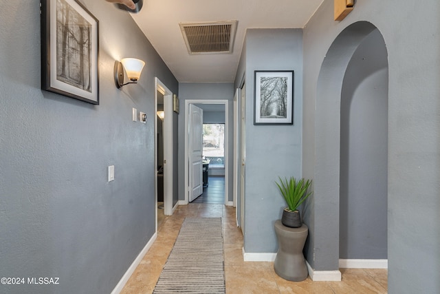 hall with light tile patterned flooring