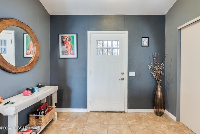 entryway with light tile patterned floors