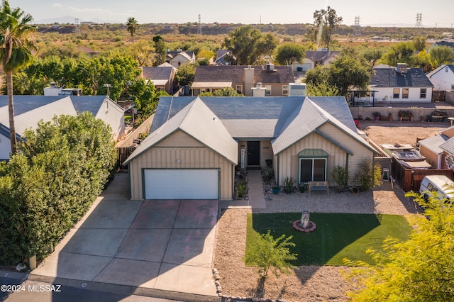 view of front of property with a front yard and a garage