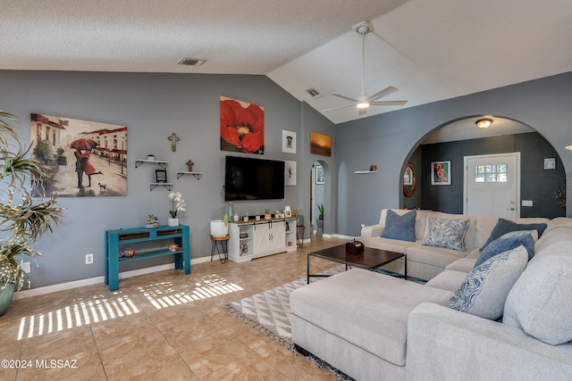 living room featuring lofted ceiling, tile patterned flooring, a textured ceiling, and ceiling fan