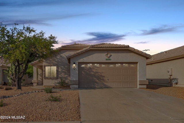 mediterranean / spanish-style house featuring a garage