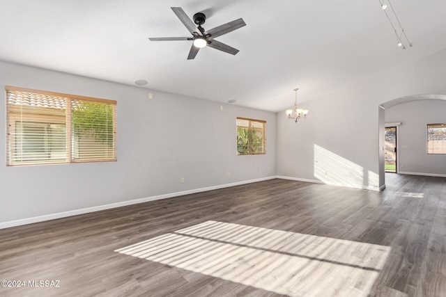 unfurnished room featuring ceiling fan with notable chandelier and dark hardwood / wood-style flooring