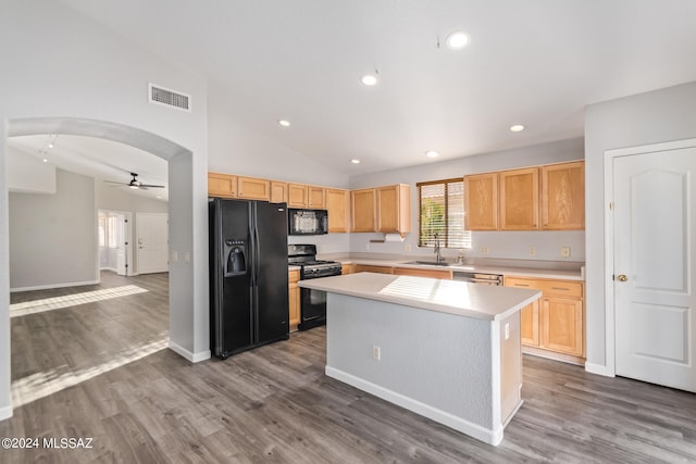 kitchen featuring ceiling fan, sink, a kitchen island, black appliances, and hardwood / wood-style floors