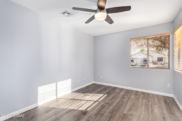 spare room with ceiling fan and wood-type flooring