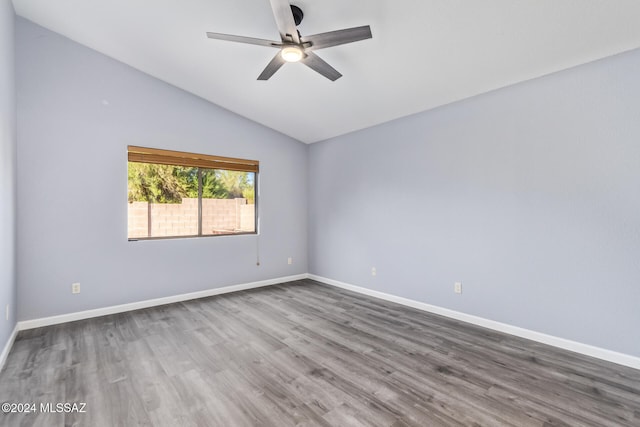 spare room with wood-type flooring, lofted ceiling, and ceiling fan