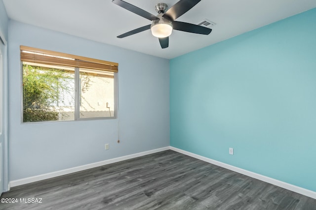 empty room with dark wood-type flooring and ceiling fan