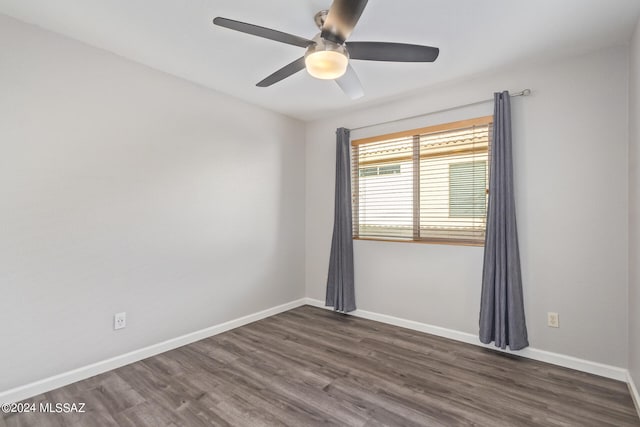 empty room with ceiling fan and dark wood-type flooring