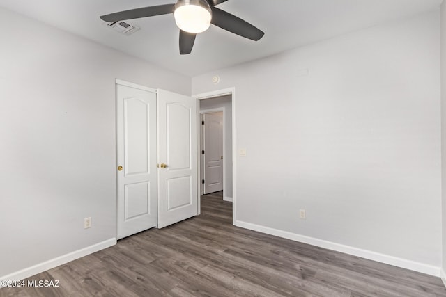 empty room featuring ceiling fan and dark hardwood / wood-style floors