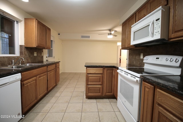 kitchen with tasteful backsplash, white appliances, sink, and light tile patterned floors