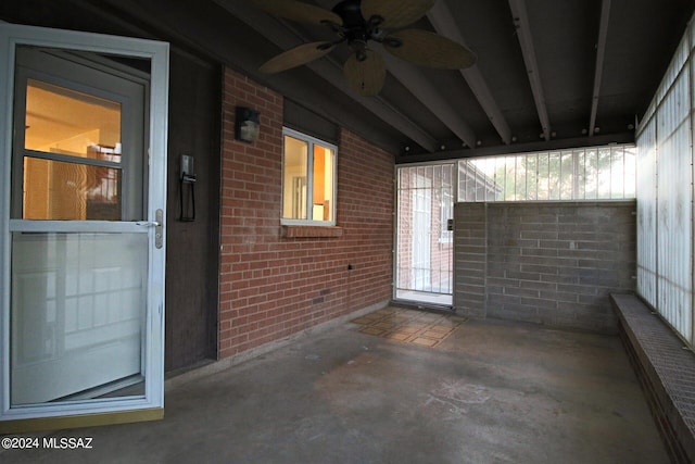 unfurnished sunroom with ceiling fan