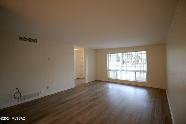 spare room featuring wood-type flooring