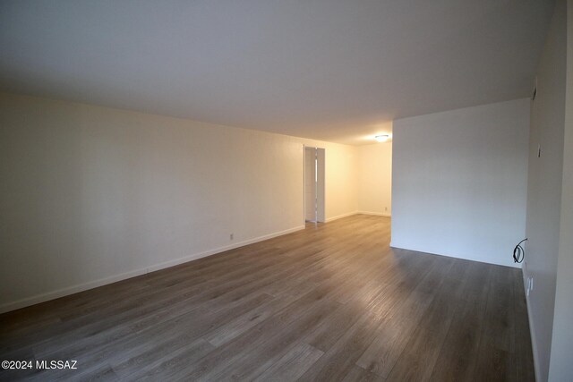 spare room with dark wood-type flooring