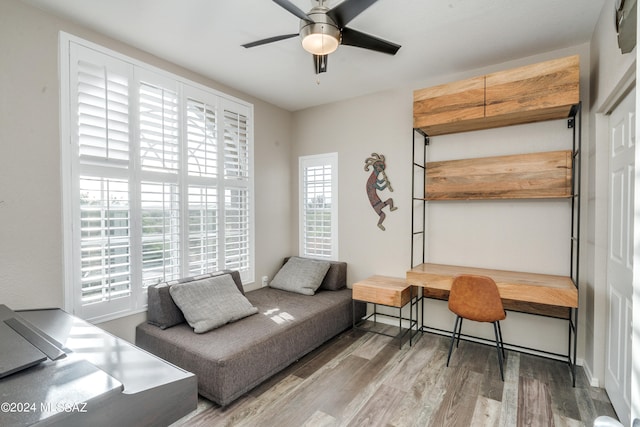 living area with ceiling fan and hardwood / wood-style floors