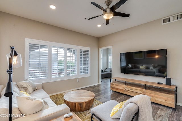 living room featuring dark hardwood / wood-style floors and ceiling fan