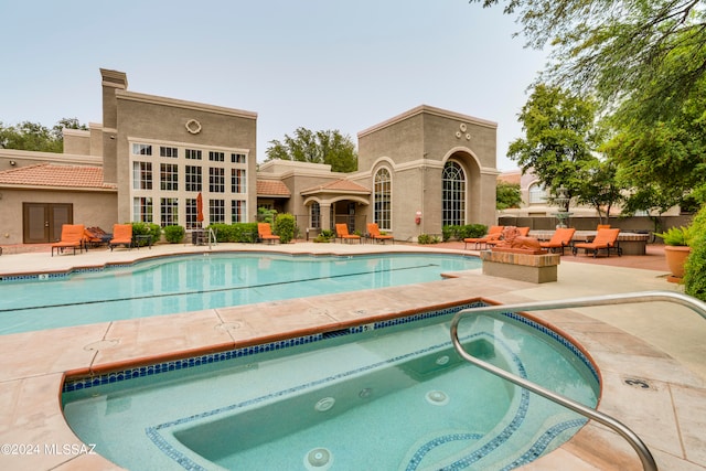 view of pool with a community hot tub and a patio