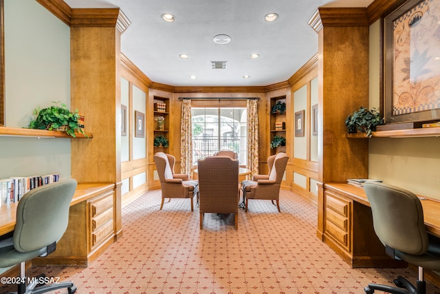 carpeted home office with crown molding and built in desk