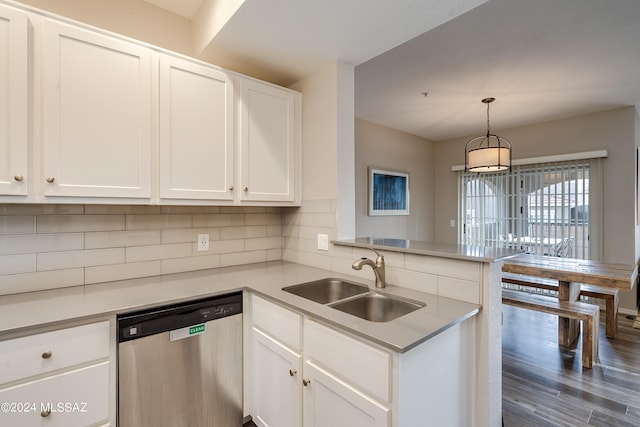 kitchen with dark wood-type flooring, sink, kitchen peninsula, white cabinets, and stainless steel dishwasher