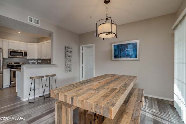 dining area with wood-type flooring