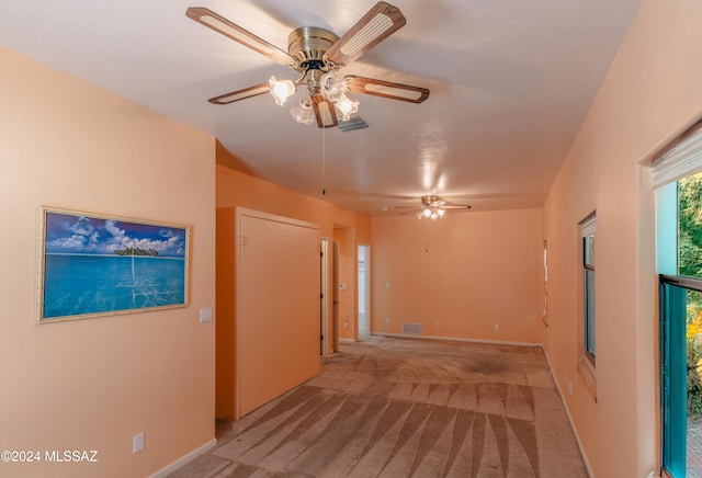 hall with light colored carpet