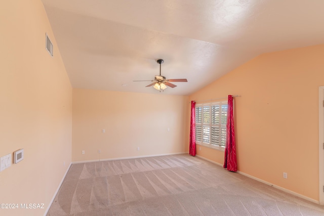 carpeted empty room with lofted ceiling and ceiling fan