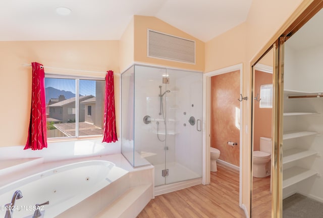 bathroom featuring vaulted ceiling, separate shower and tub, hardwood / wood-style floors, and toilet