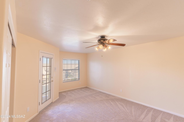 unfurnished room with light carpet and ceiling fan