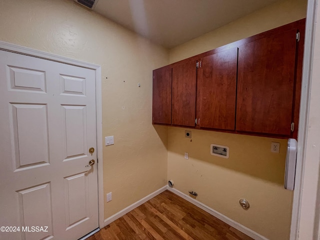 laundry area featuring cabinets, light hardwood / wood-style flooring, hookup for a washing machine, electric dryer hookup, and hookup for a gas dryer