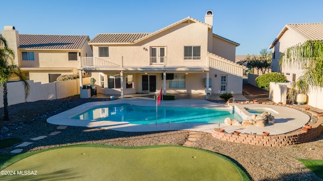 view of swimming pool with an in ground hot tub and a patio area