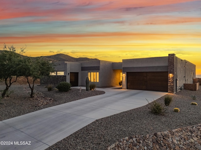 view of front facade with a mountain view and a garage