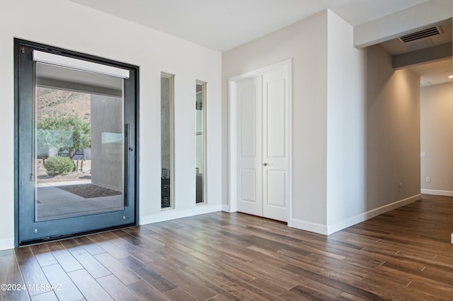 unfurnished room featuring dark hardwood / wood-style flooring