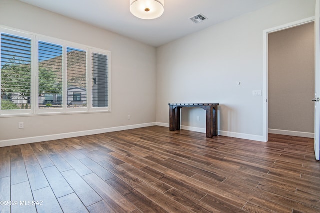 spare room with dark hardwood / wood-style flooring