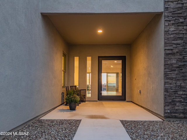 property entrance featuring a patio area