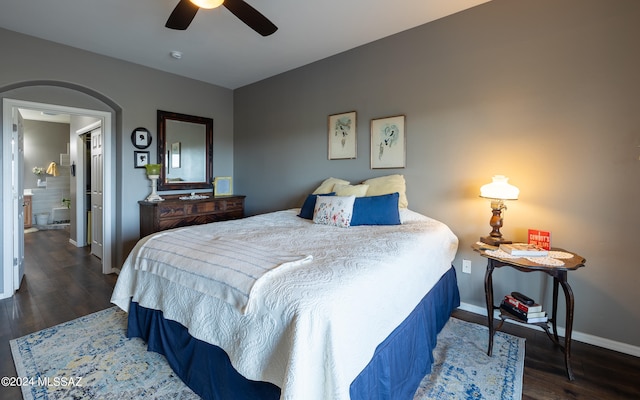 bedroom with dark hardwood / wood-style flooring and ceiling fan