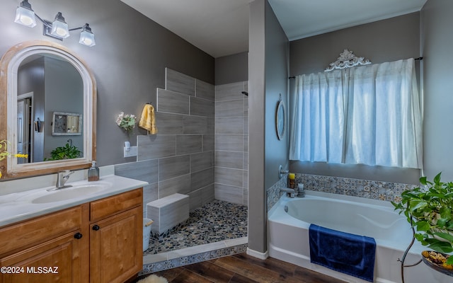 bathroom featuring independent shower and bath, vanity, and hardwood / wood-style floors