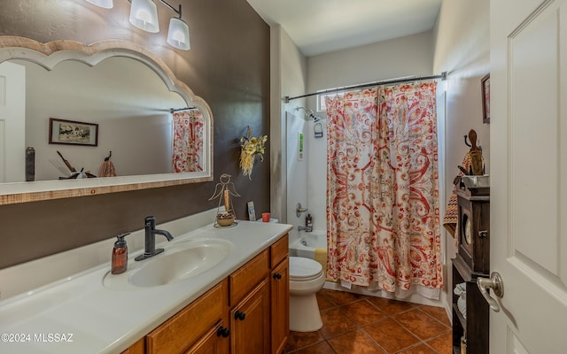 full bathroom with shower / tub combo, tile patterned floors, vanity, and toilet