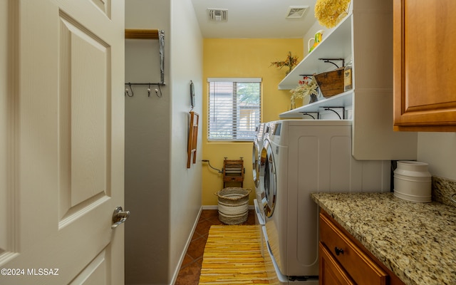 laundry room with independent washer and dryer, cabinets, and light tile patterned floors