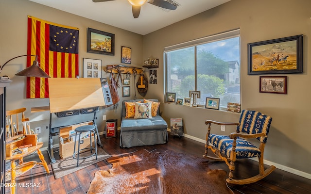 sitting room featuring ceiling fan and dark hardwood / wood-style floors