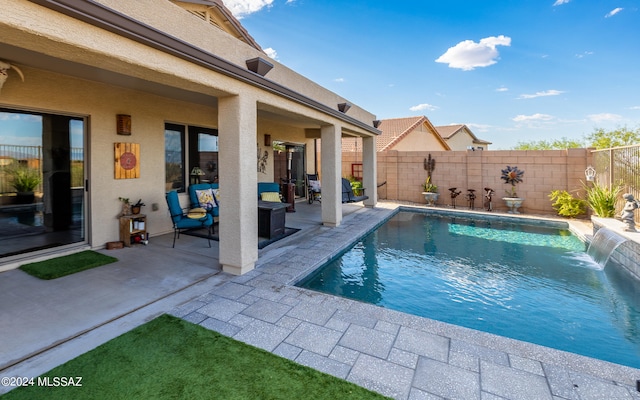 view of pool featuring pool water feature and a patio area