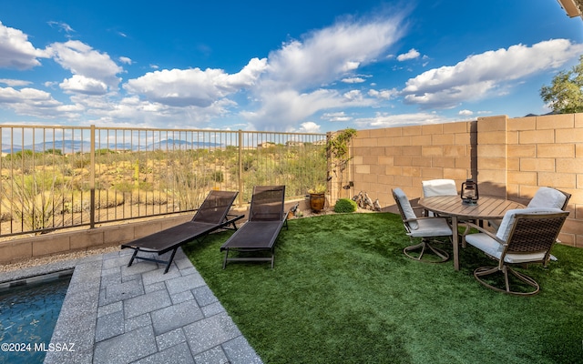 view of yard featuring a water view and a patio