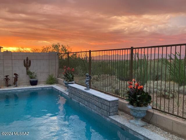 view of pool at dusk