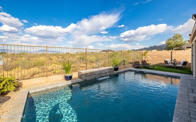 view of swimming pool with a mountain view and pool water feature