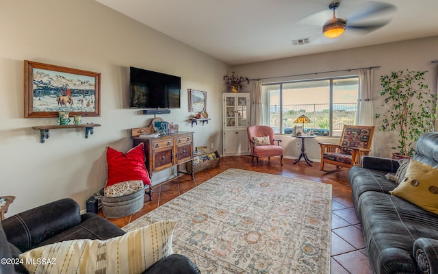 living room with tile patterned flooring and ceiling fan